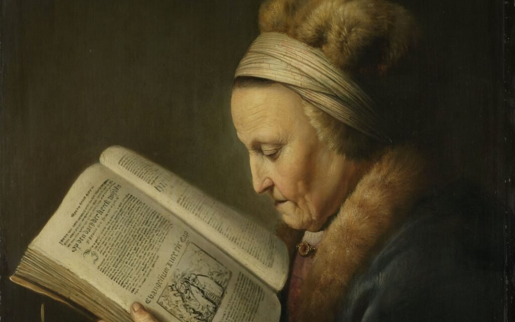 An elderly woman in a fur-trimmed gown reads a large open book by candlelight